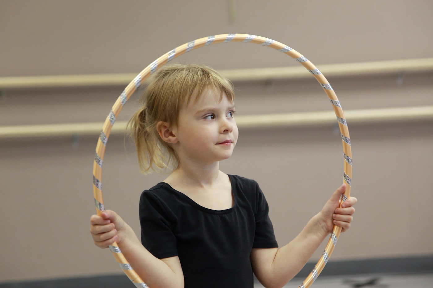 Young girl dancing with a hula hoop