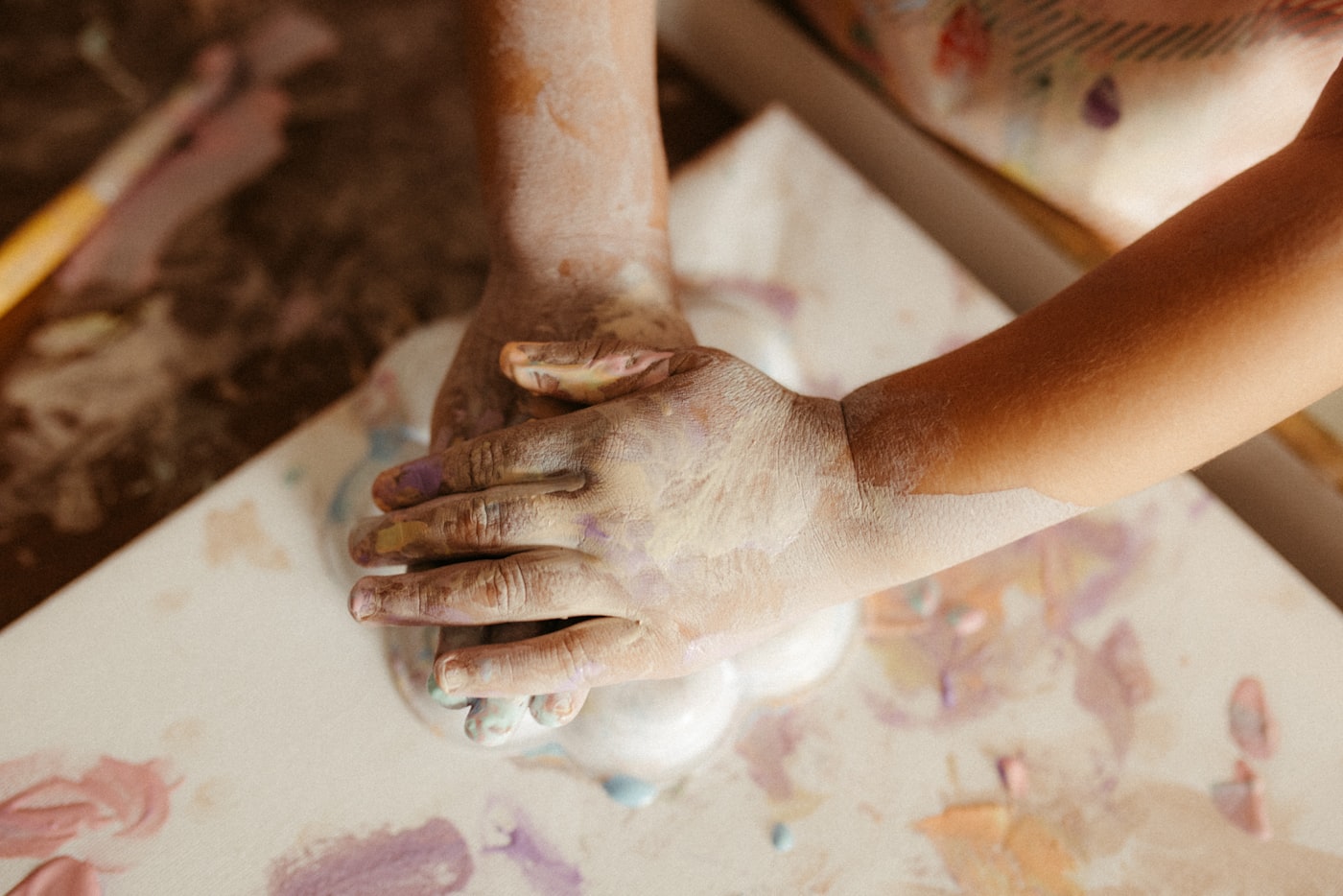 Child's hands covered in paint